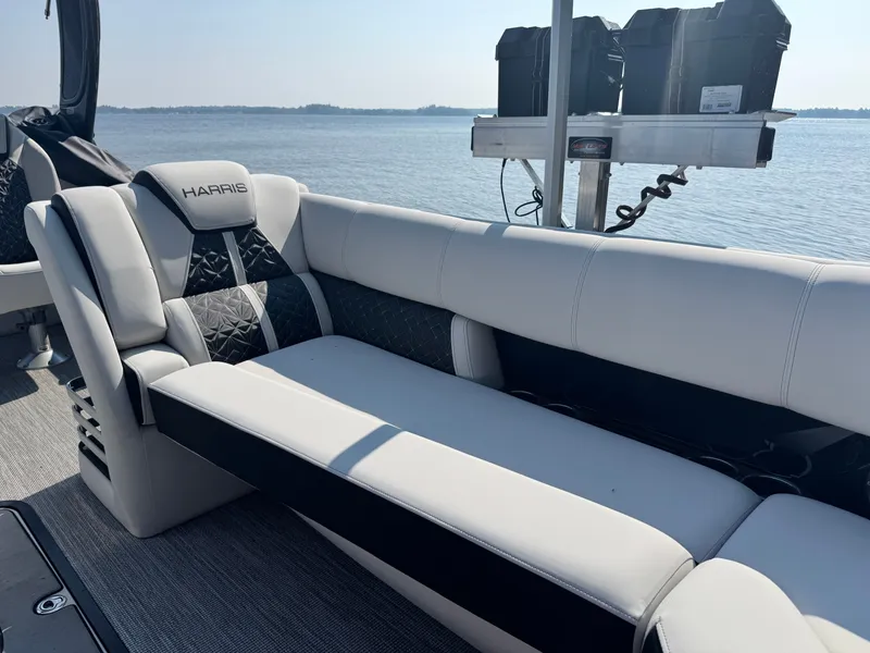 Slide: The Image of 2024 Harris 250 Grand Mariner boat interior with luxurious seating and scenic water view. - 7