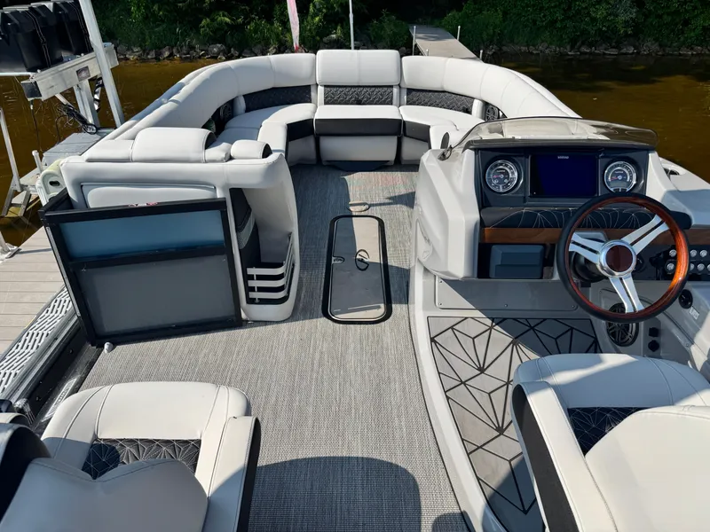 Slide: The Image of 2024 Harris 250 Grand Mariner boat interior with luxurious seating and modern dashboard. - 9