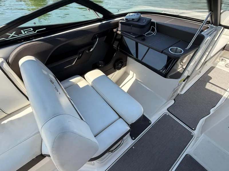 Slide: The Image of 2017 Sea Ray SLX 230 boat interior with white seating and storage area. - 16