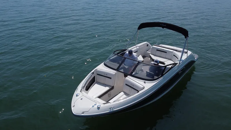 Slide: The Image of 2017 Sea Ray SLX 230 boat on calm water, featuring sleek design and spacious seating. - 5