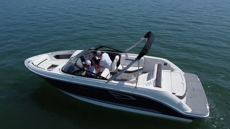 Slide: The Image of 2017 Sea Ray SLX 230 boat cruising on open water, featuring sleek design and spacious seating. - 8