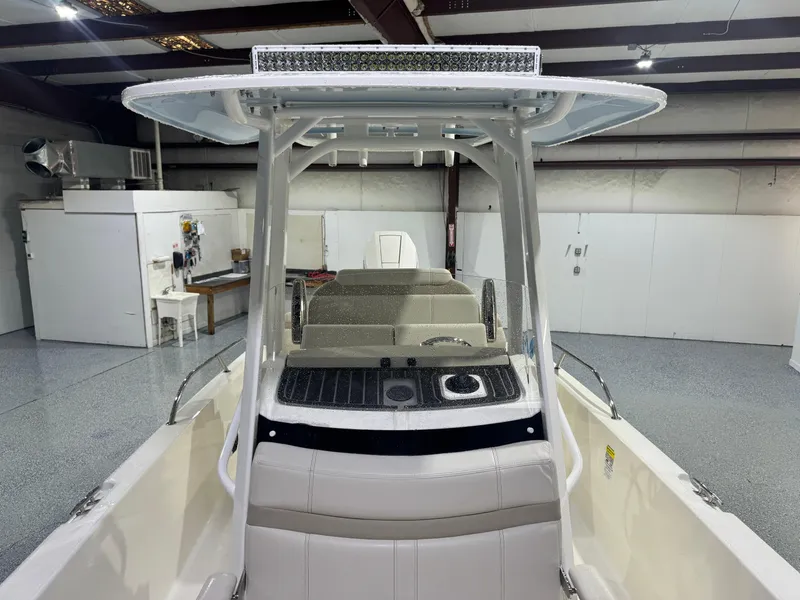 Slide: The Image of 2024 Boston Whaler 250 Dauntless helm with steering wheel, controls, and navigation displays. - 10