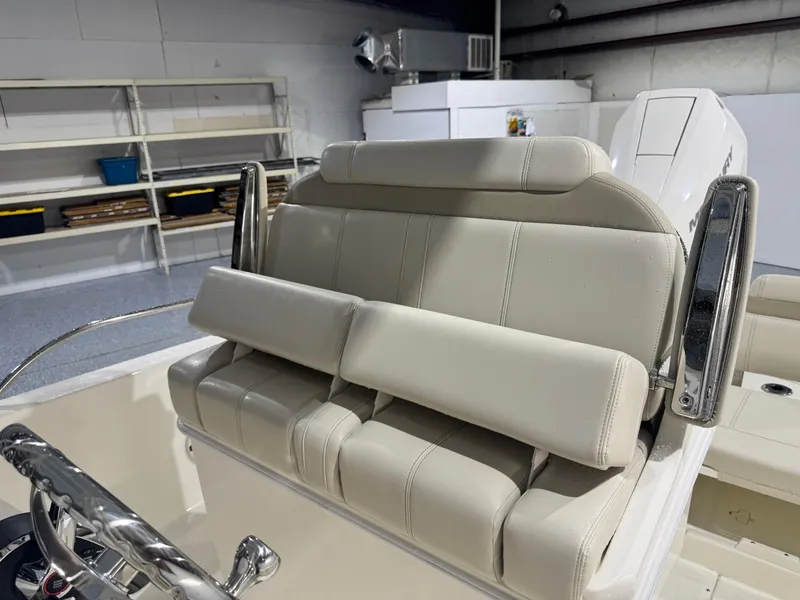 Slide: The Image of 2024 Boston Whaler 250 Dauntless boat with spacious seating and sleek design in a marina. - 11