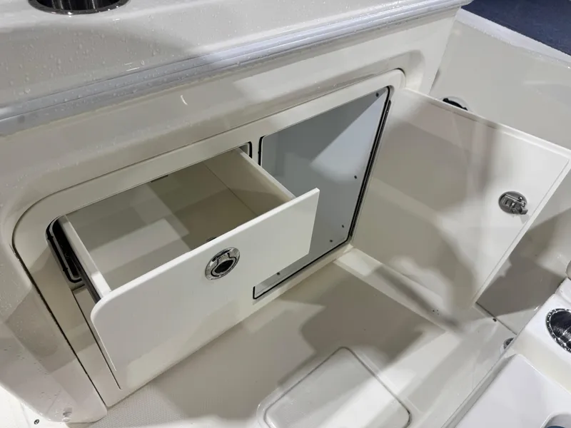Slide: The Image of 2024 Boston Whaler 250 Dauntless helm with Simrad electronics and dual cup holders. - 14