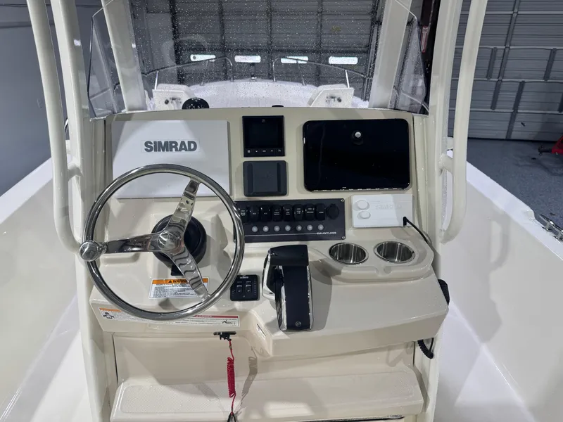 Slide: The Image of 2024 Boston Whaler 250 Dauntless boat interior with seating and speakers in a garage. - 15
