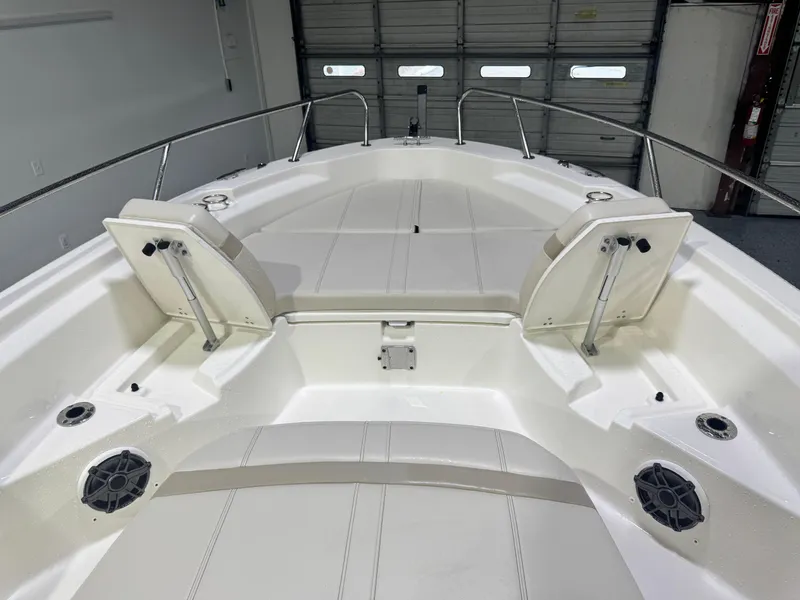 Slide: The Image of 2024 Boston Whaler 250 Dauntless boat interior with seating and Mercury engine. - 8