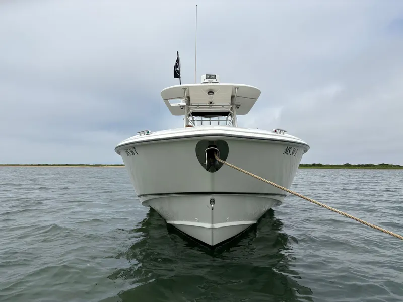 Slide: The Image of 2005 Boston Whaler 320 Outrage boat anchored on calm water. - 10