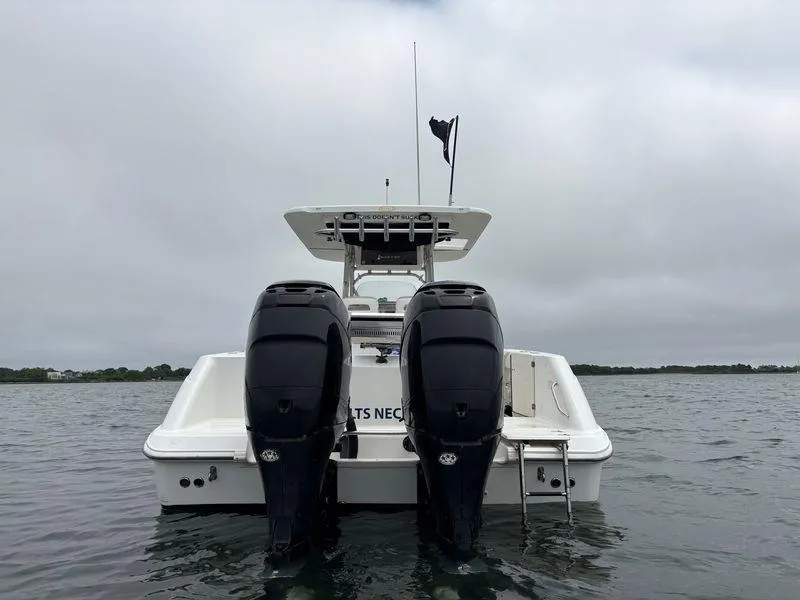 Slide: The Image of 2005 Boston Whaler 320 Outrage with dual engines on a cloudy day. - 11