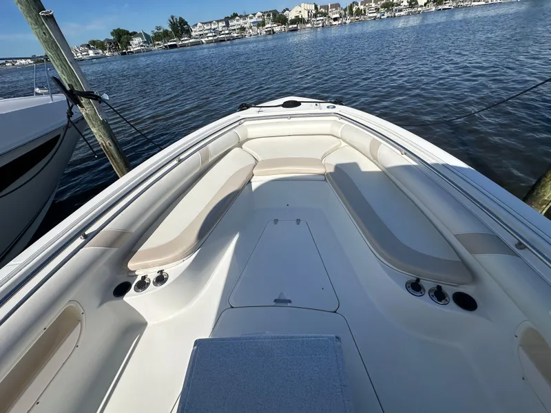 Slide: The Image of 2005 Boston Whaler 320 Outrage boat interior with seating, docked by the water. - 16