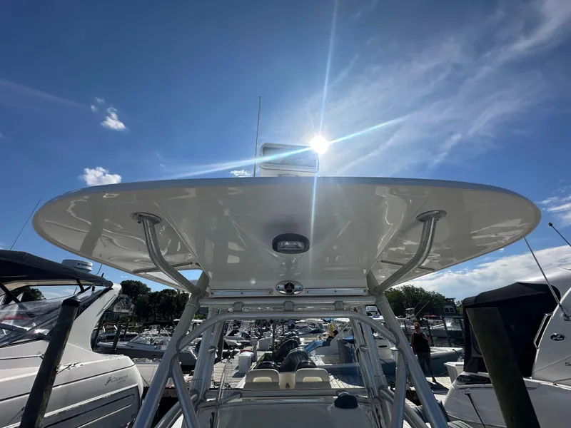Slide: The Image of 2005 Boston Whaler 320 Outrage boat with T-top under sunny sky at marina. - 20