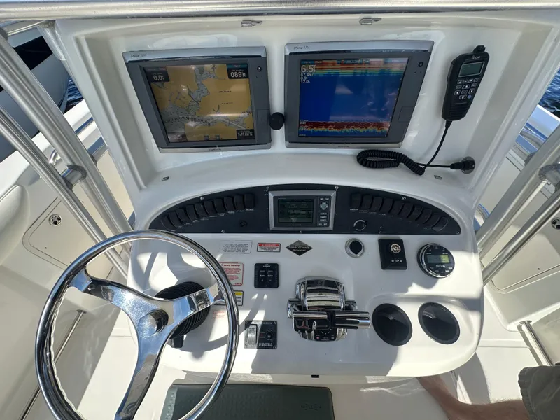 Slide: The Image of 2005 Boston Whaler 320 Outrage helm with navigation screens and controls. - 25