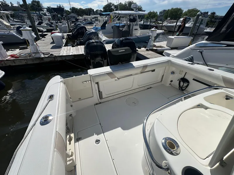 Slide: The Image of 2005 Boston Whaler 320 Outrage boat docked at marina, showcasing spacious deck area. - 28