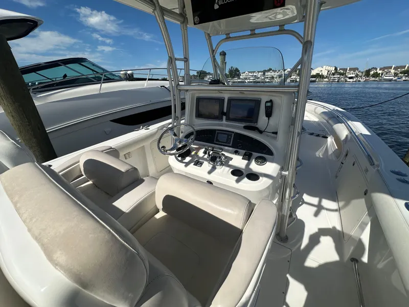 Slide: The Image of 2005 Boston Whaler 320 Outrage boat cockpit with steering wheel and navigation screens. - 29