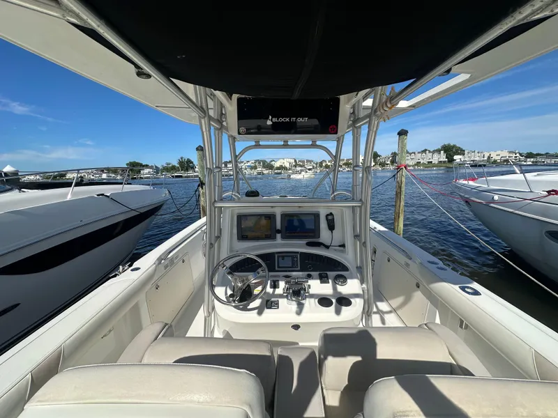 Slide: The Image of 2005 Boston Whaler 320 Outrage boat interior with steering console, docked at marina. - 31