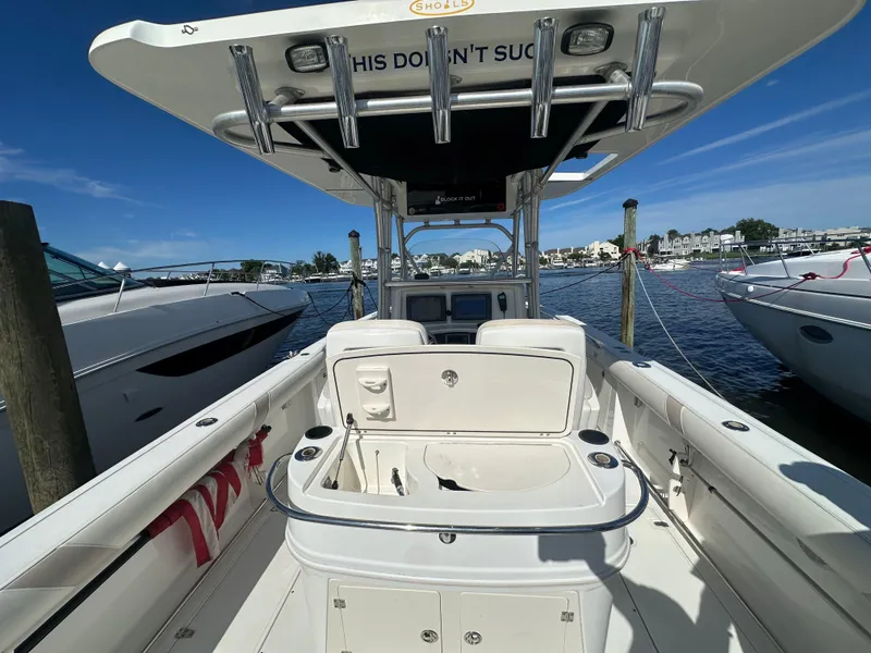 Slide: The Image of 2005 Boston Whaler 320 Outrage boat docked at marina, clear sky, calm water. - 32