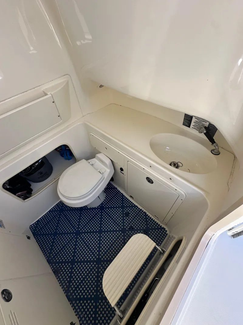 Slide: The Image of 2005 Boston Whaler 320 Outrage boat interior with toilet and sink. - 36
