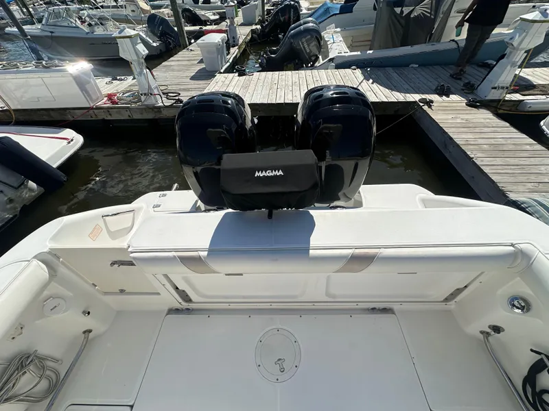 Slide: The Image of 2005 Boston Whaler 320 Outrage at dock, featuring dual outboard engines. - 37