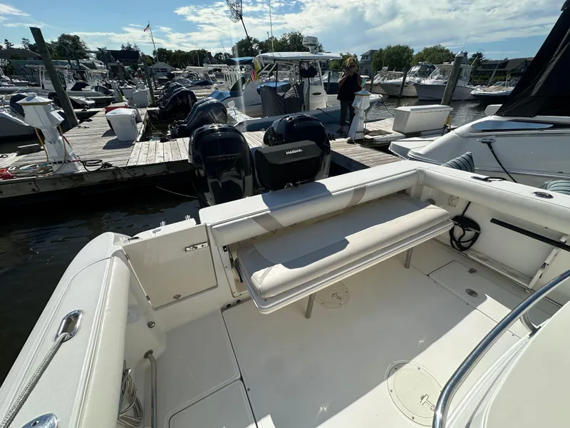 Slide: The Image of 2005 Boston Whaler 320 Outrage at marina, featuring spacious deck and twin engines. - 39