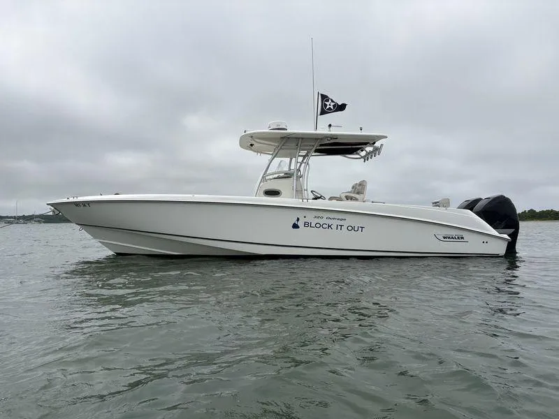 The Image of 2005 Boston Whaler 320 Outrage boat on water, overcast sky, side view. - 8