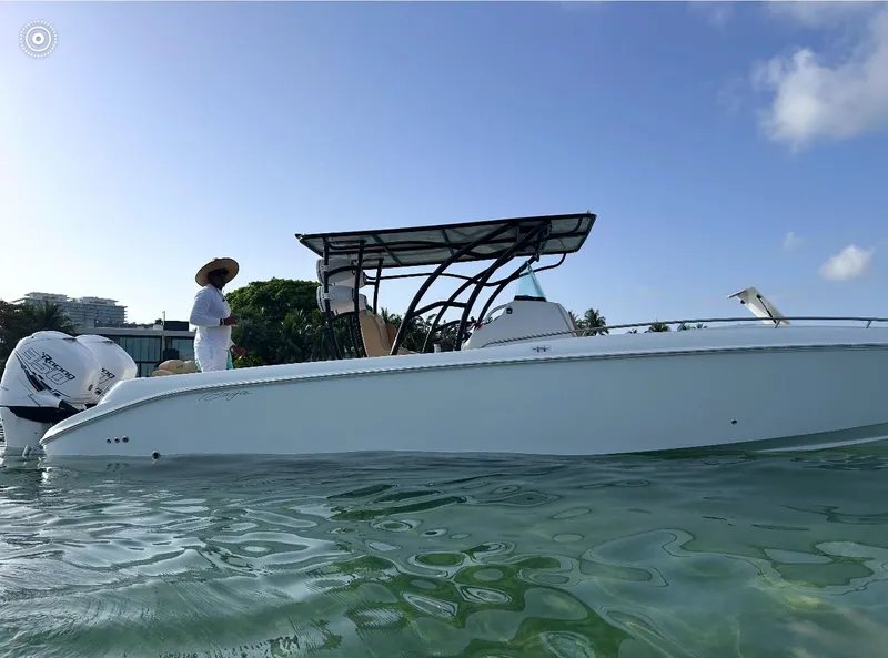 Slide: The Image of 2002 Baja 340 Islander Outboard boat on water, with a person standing onboard. - 13