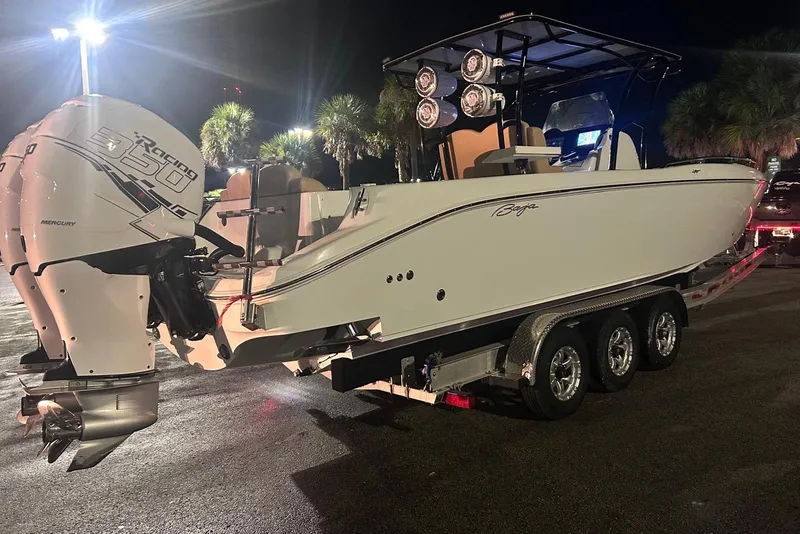 Slide: The Image of 2002 Baja 340 Islander Outboard boat on trailer, illuminated at night with powerful engines. - 18
