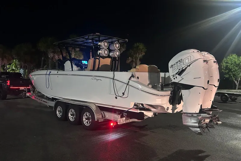 Slide: The Image of 2002 Baja 340 Islander Outboard cruising on a sunny day with cityscape background. - 17