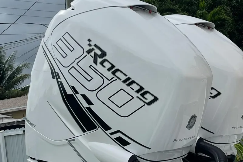 Slide: The Image of 2002 Baja 340 Islander Outboard cruising on water with city skyline backdrop. - 2