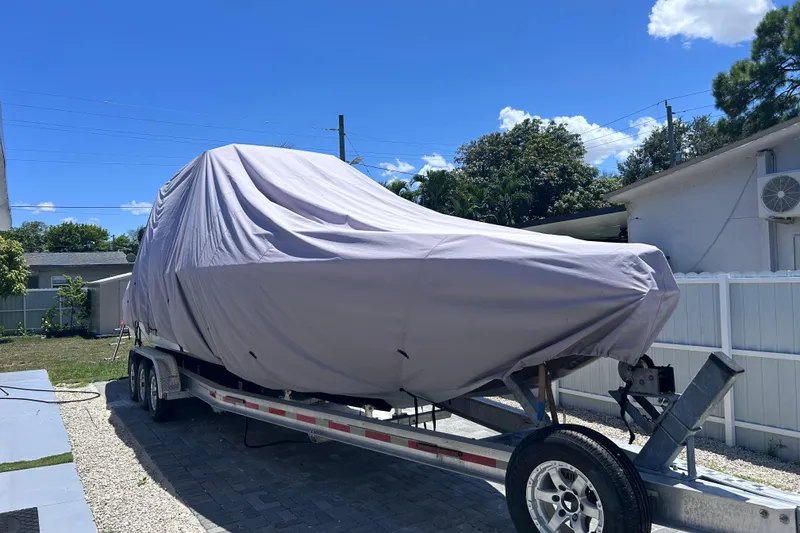 Slide: The Image of Covered 2002 Baja 340 Sportfish on trailer in sunny yard. - 20
