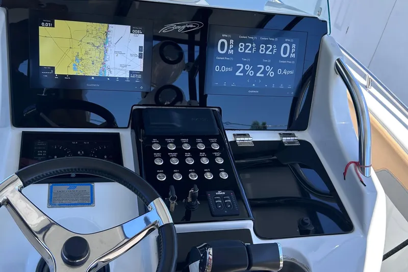 Slide: The Image of 2002 Baja 340 Islander Outboard docked, featuring twin engines and tan seating. - 4