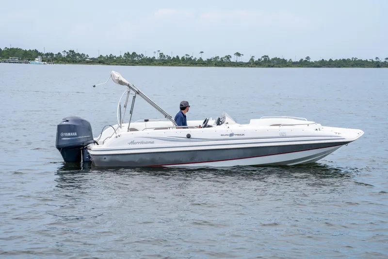 Slide: The Image of 2013 Hurricane SunDeck Sport 201 OB boat on calm water with Yamaha outboard motor. - 1