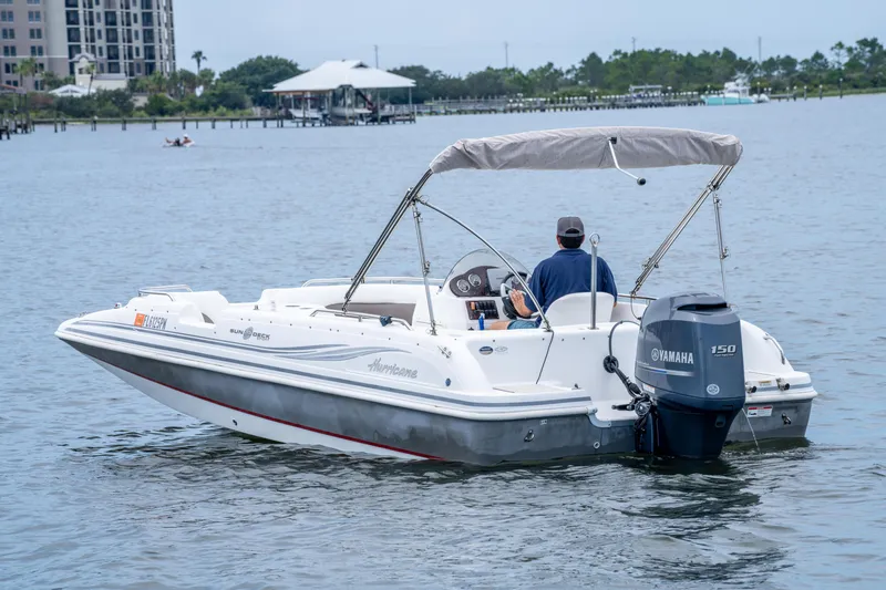 Slide: The Image of 2013 Hurricane SunDeck Sport 201 OB boat on water with Yamaha engine. - 10