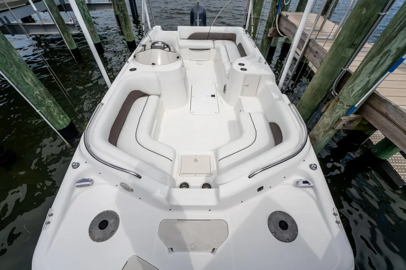 Slide: The Image of 2013 Hurricane SunDeck Sport 201 OB boat docked, featuring spacious seating and sleek design. - 14