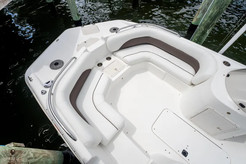 Slide: The Image of 2013 Hurricane SunDeck Sport 201 OB boat interior with white seating and water view. - 16