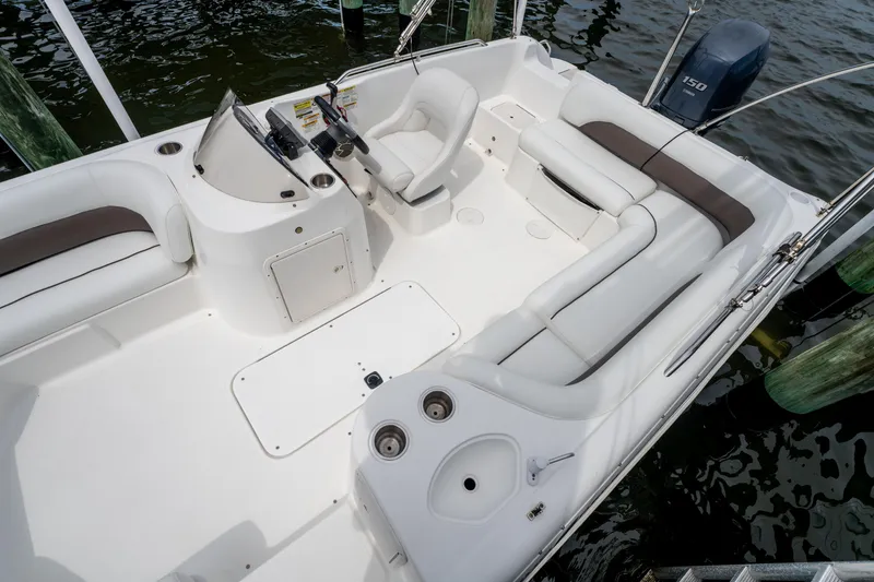 Slide: The Image of 2013 Hurricane SunDeck Sport 201 OB boat interior with seating and steering console. - 17