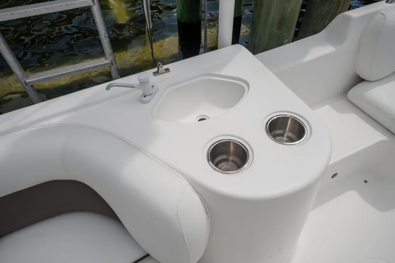 Slide: The Image of 2013 Hurricane SunDeck Sport 201 OB boat interior with sink and cup holders. - 22