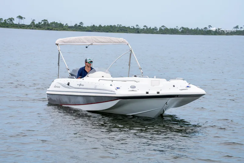 Slide: The Image of 2013 Hurricane SunDeck Sport 201 OB boat cruising on calm water. - 3