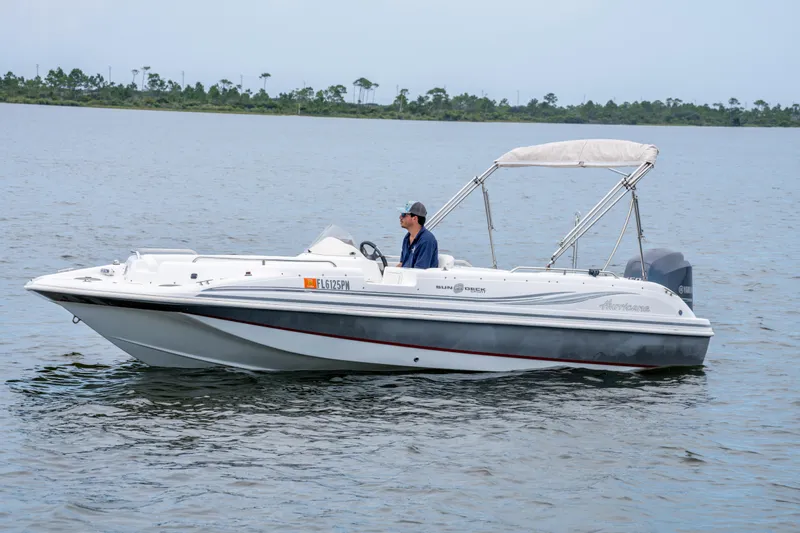 Slide: The Image of 2013 Hurricane SunDeck Sport 201 OB boat on calm water with canopy. - 7
