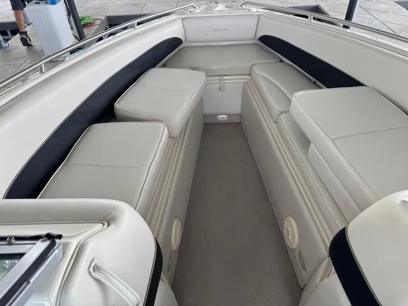 Slide: The Image of Interior of a 2000 Crownline 266 BR boat with white cushioned seating. - 5