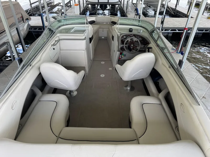 Slide: The Image of Interior of a 2000 Crownline 266 BR boat with white seating and dashboard. - 6