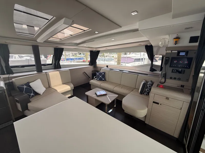 Slide: The Image of Luxurious interior of 2023 Fountaine Pajot Aura 51 catamaran with modern seating and large windows. - 15