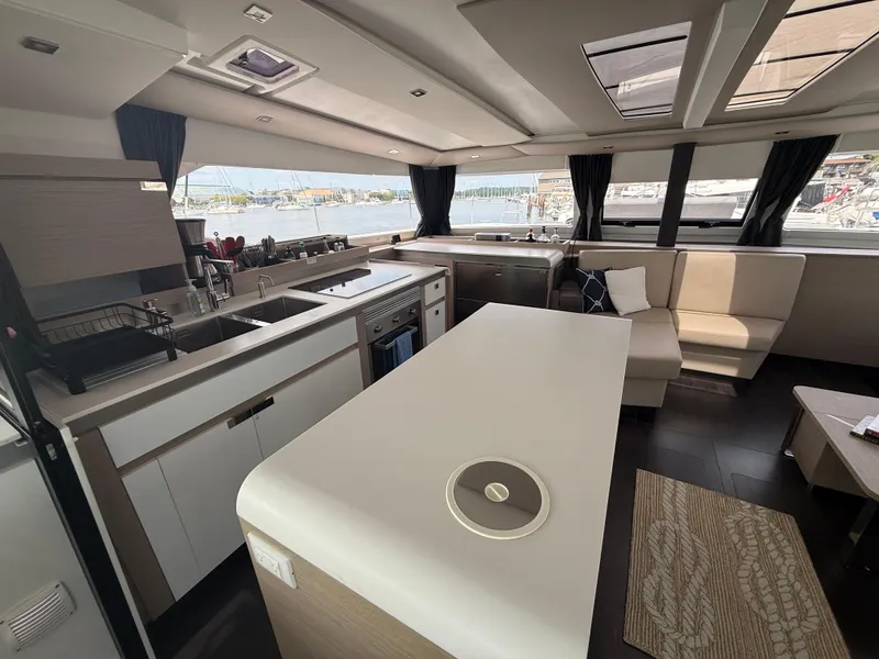 Slide: The Image of Luxurious interior of 2023 Fountaine Pajot Aura 51 catamaran with modern kitchen and seating area. - 17
