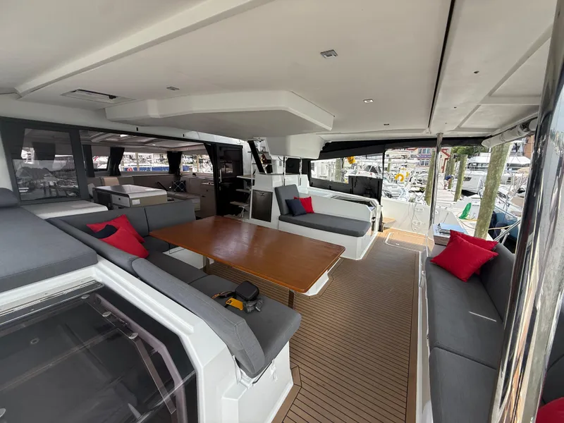 Slide: The Image of Luxurious interior of 2023 Fountaine Pajot Aura 51 catamaran with spacious seating and dining area. - 2
