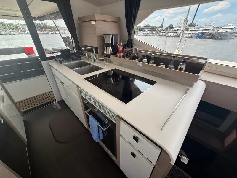 Slide: The Image of Modern kitchen interior on 2023 Fountaine Pajot Aura 51 yacht, featuring sleek design and appliances. - 20