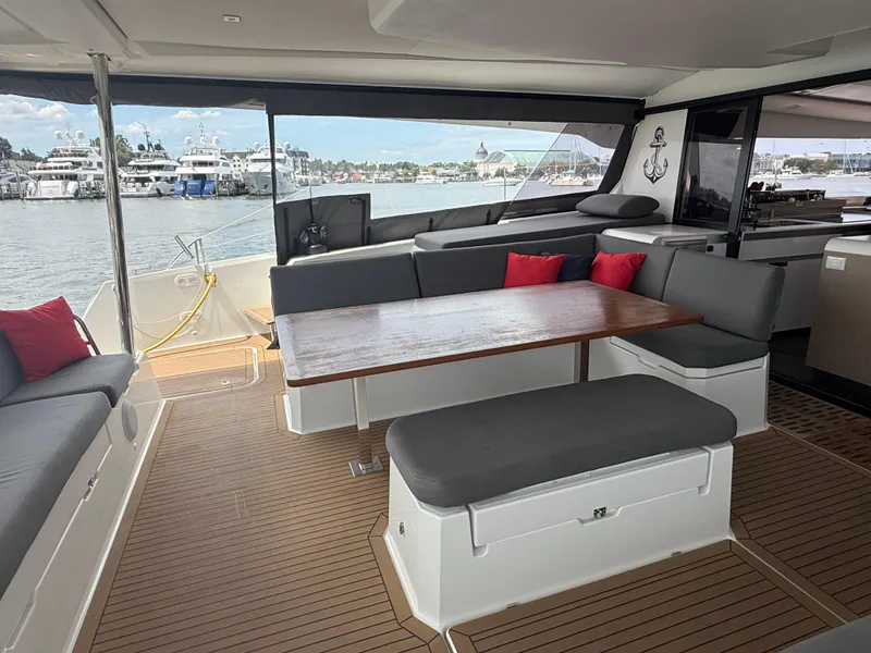 Slide: The Image of 2023 Fountaine Pajot Aura 51 yacht interior with elegant seating and wooden table. - 4