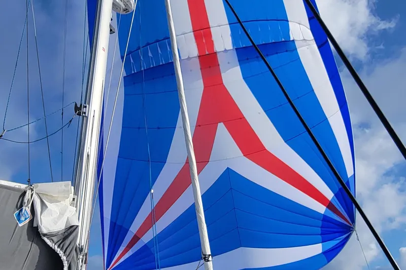 Slide: The Image of Sail of 2023 Fountaine Pajot Aura 51 catamaran against blue sky. - 47