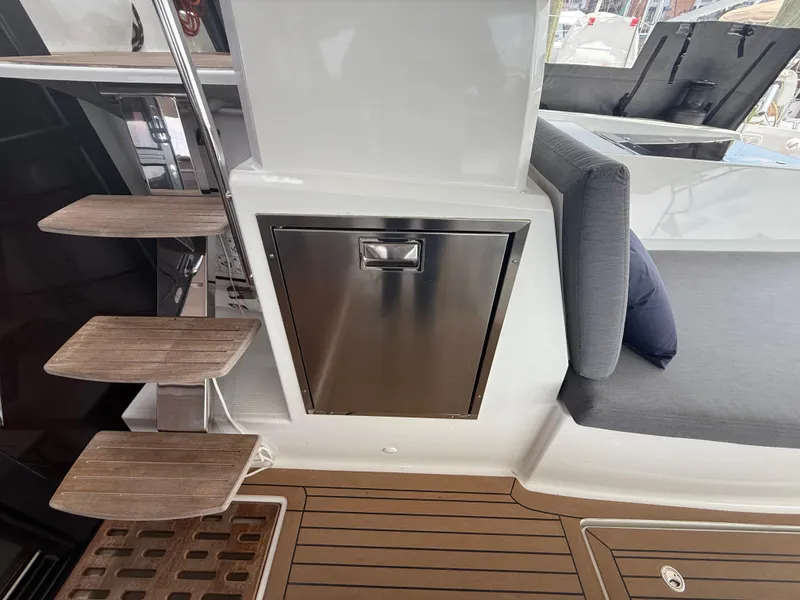Slide: The Image of 2023 Fountaine Pajot Aura 51 yacht interior with wooden steps and stainless steel cabinet. - 6