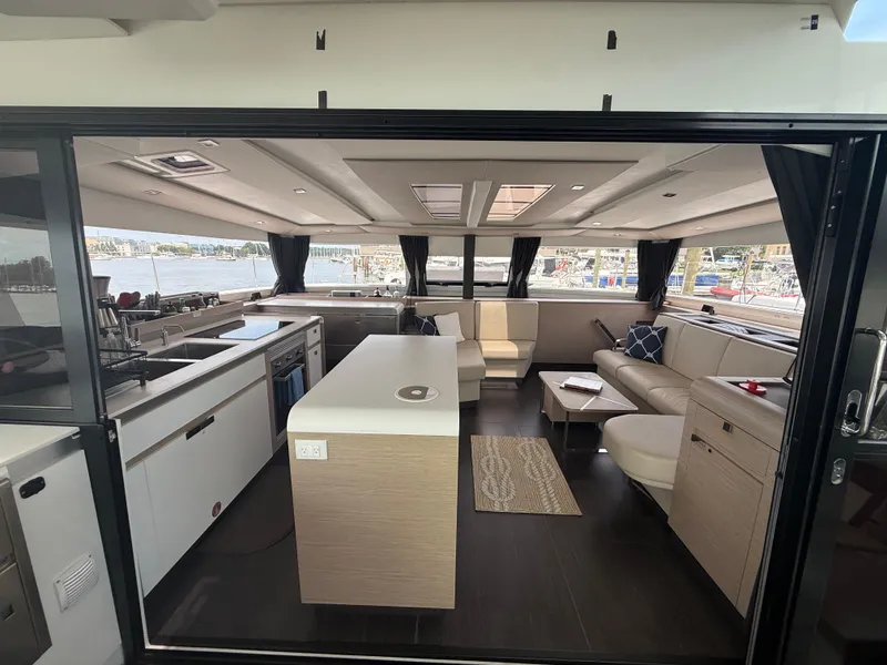 Slide: The Image of Luxurious interior of 2023 Fountaine Pajot Aura 51 catamaran with modern kitchen and seating area. - 9