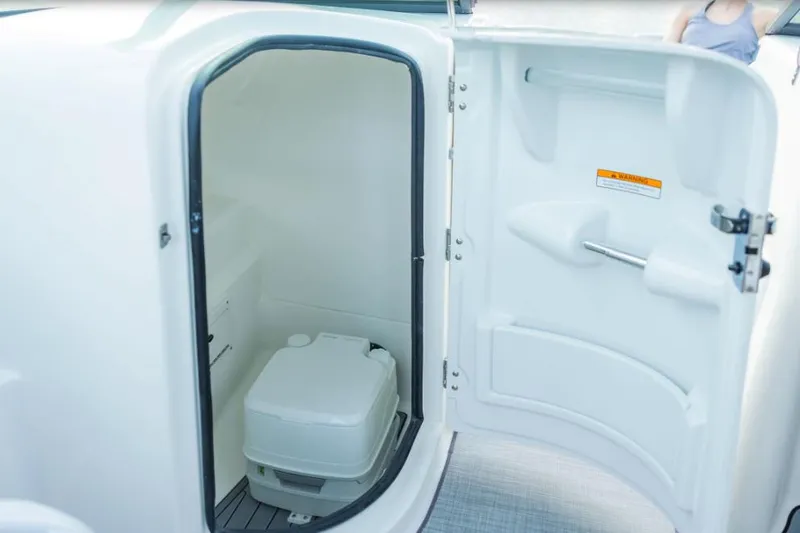 Slide: The Image of Manufacturer Provided Image: 2022 NauticStar 243 DC boat interior with compact toilet compartment. - 4