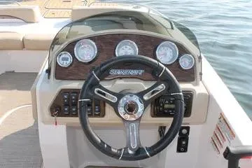 Slide: The Image of 2017 Starcraft Star Step 221 OB boat dashboard with steering wheel and gauges. - 14
