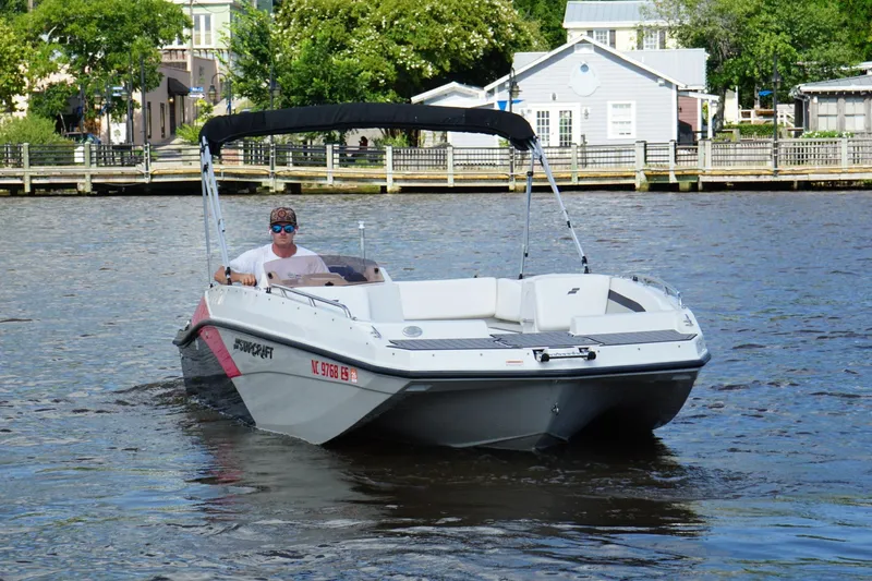 Slide: The Image of 2017 Starcraft Star Step 221 OB boat cruising on a river near a dock. - 3